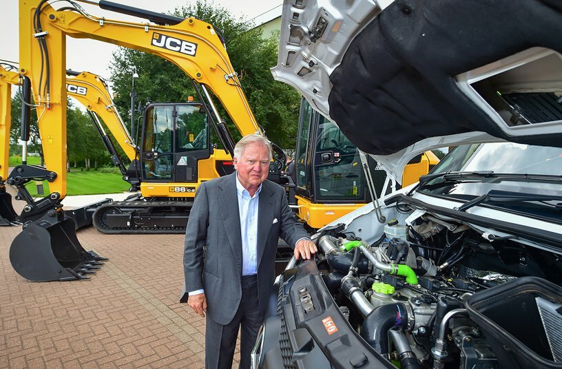 Lord Bamford pictured with the retrofitted white van <br>IMAGE SOURCE: JCB