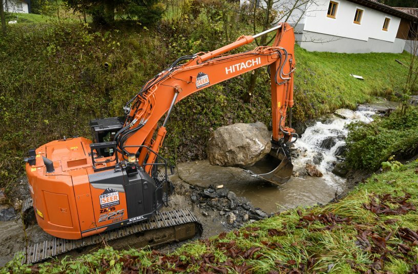 Der Kettenbagger der Firma Rupert Seer ist mit einem Tiltrotator R6 für Bagger mit einem Dienstgewicht von bis zu 24 t ausgestattet. Mit dem rosbusten Gespann und dem Rototilt-Tieflöffel lässt sich ein schwerer Felsbrocken punktgenau umsetzen. <br>BILDQUELLE: Rototilt GmbH