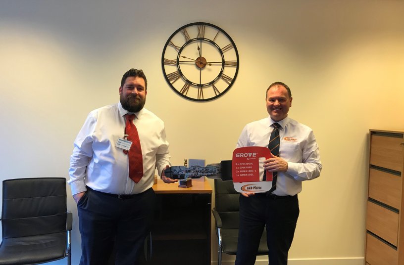 James Leishman, sales manager at Manitowoc UK, presents Derek Pierce, managing director of J & D Pierce, with a ceremonial key representing the handover of the cranes. <br> Image source: MANITOWOC COMPANY, INC.