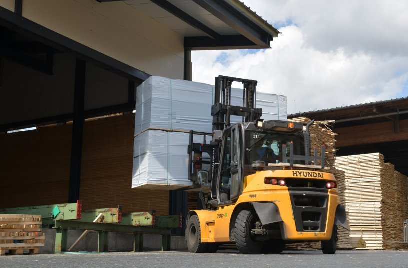 Hyundai 70D-9 with two heavy stacks of lumber en route to the lorry loading point; the 10 t forklifts are used constantly at Ziegler in a three-shift operating regime. <br> Image source: Hyundai/OB