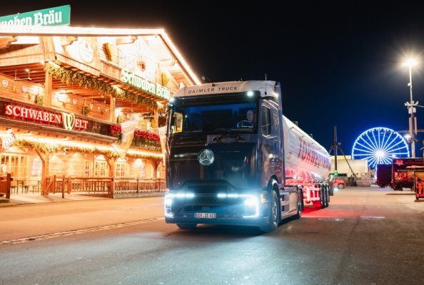 The Mercedes-Benz eActros 600, adorned in a distinctive dirndl and lederhosen-themed wrap, delivers supplies to the Schwabenbräu festival tent at the Cannstatter Volksfest.