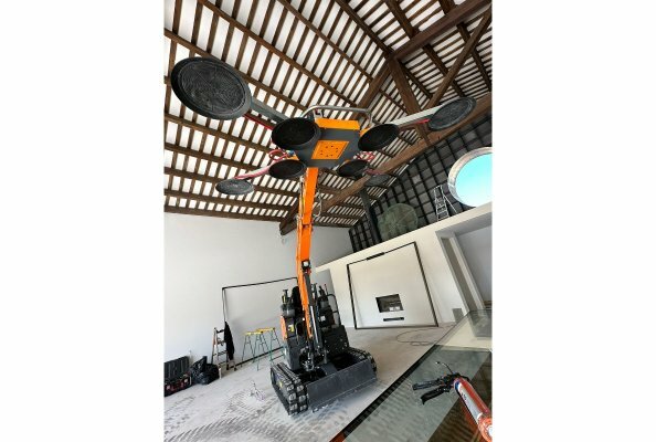 Develon Mini-Excavator Used to Install Panes of Glass in Home