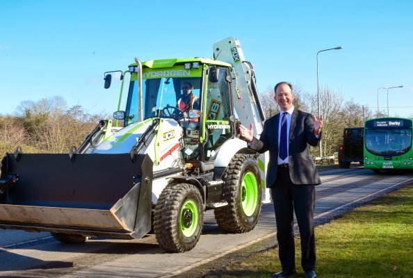 Technology and Decarbonisation Minister Jesse Norman pictured in Rocester, Staffordshire, today with a JCB backhoe loader powered by a hydrogen combustion engine. The visit came as the Government grants approval for the machine to be driven on UK roads.