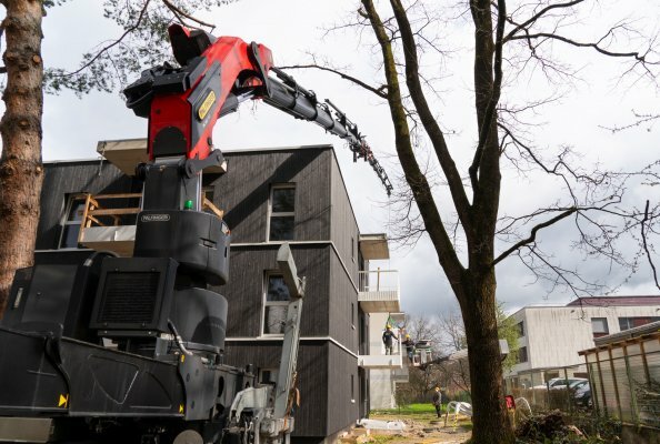Balcony railing sections must be safely hoisted over the multi-unit building — a task the PK 580 TEC masters effortlessly.
